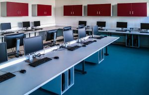 Room with computers in a row.